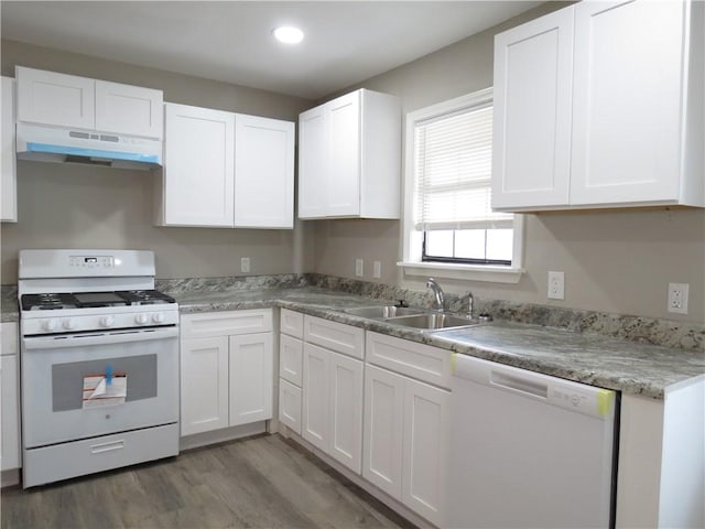 kitchen with dark wood-type flooring, sink, white cabinets, and white appliances