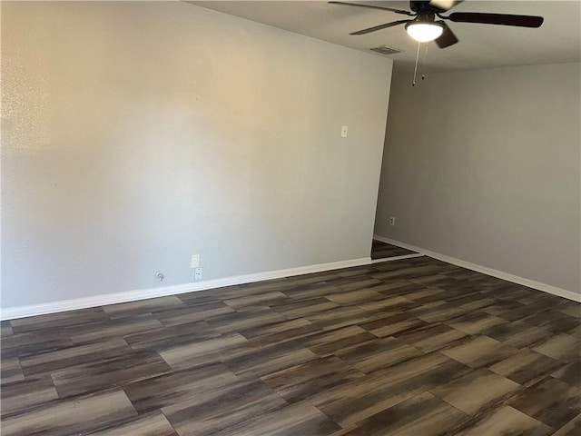 unfurnished room with dark hardwood / wood-style floors and ceiling fan