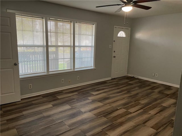 entryway with dark hardwood / wood-style flooring and ceiling fan