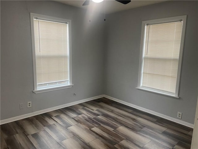 empty room featuring dark wood-type flooring and ceiling fan