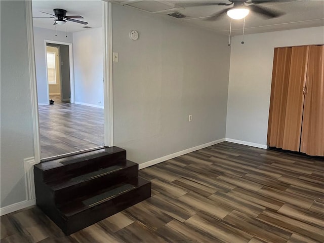 spare room with dark wood-type flooring and ceiling fan