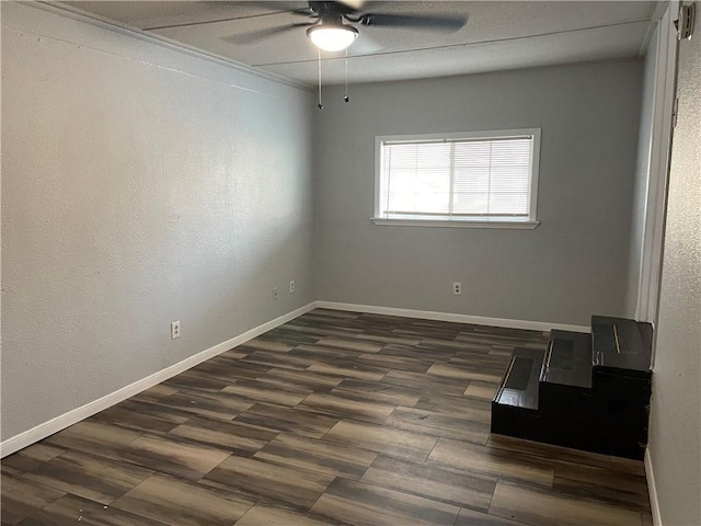 spare room featuring dark hardwood / wood-style floors and ceiling fan