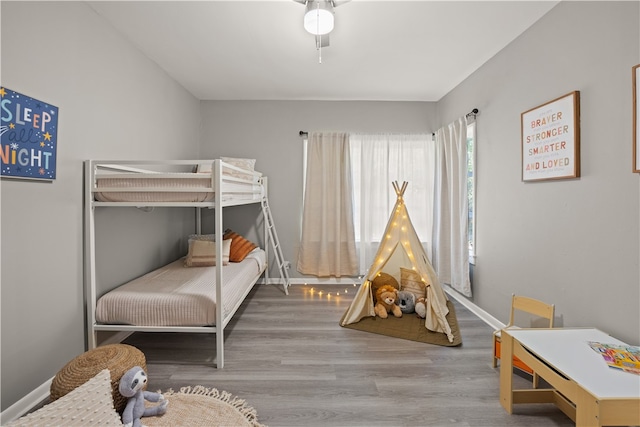 bedroom with ceiling fan and wood-type flooring