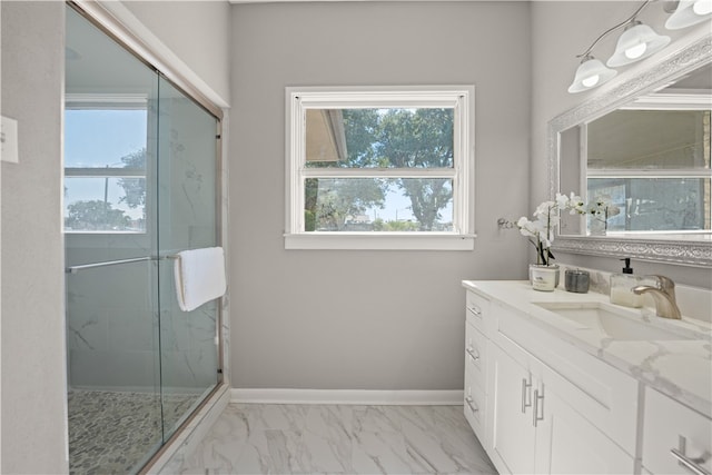 bathroom with vanity, walk in shower, and a wealth of natural light