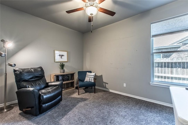 sitting room featuring baseboards, carpet floors, and ceiling fan