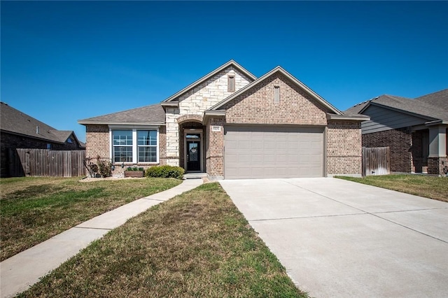 view of front facade featuring a front lawn, fence, concrete driveway, an attached garage, and brick siding