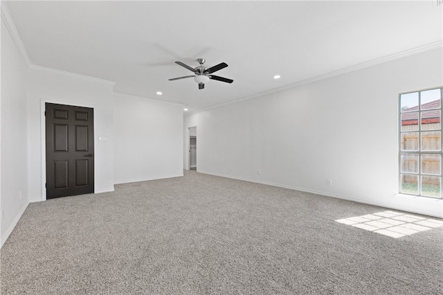 carpeted spare room featuring ornamental molding, ceiling fan, and a healthy amount of sunlight