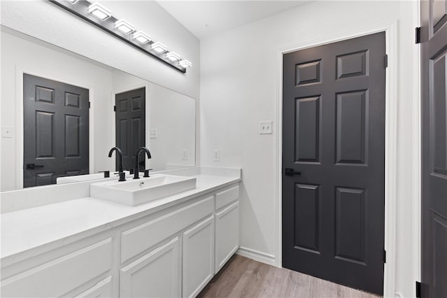 bathroom featuring hardwood / wood-style floors and vanity