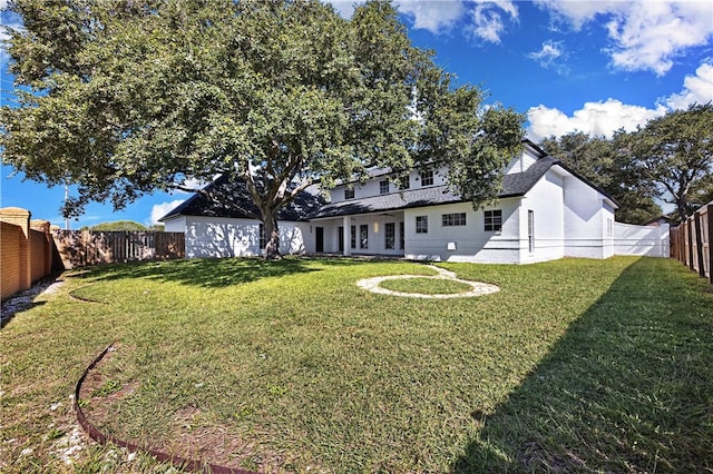 rear view of house with a yard