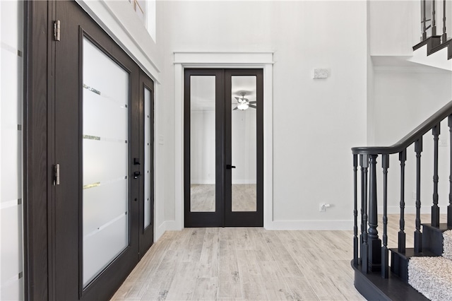 entryway with light wood-type flooring and french doors