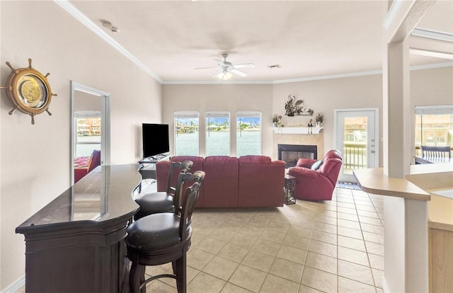 15410 Grass Cay Ct Unit A, Corpus Christi, TX 78418 - living room with light tile patterned floors, a tile fireplace, ceiling fan, and a wealth of natural light