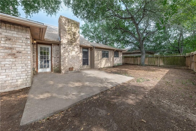 2413 Cricket Hollow St, Corpus Christi, TX 78414 - rear view of house featuring a chimney, a fenced backyard, a patio, and brick siding
