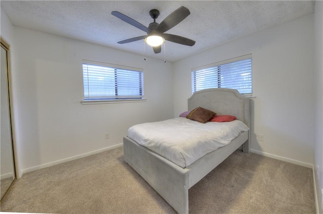 2413 Cricket Hollow St, Corpus Christi, TX 78414 - bedroom with light carpet, a textured ceiling, baseboards, and a ceiling fan