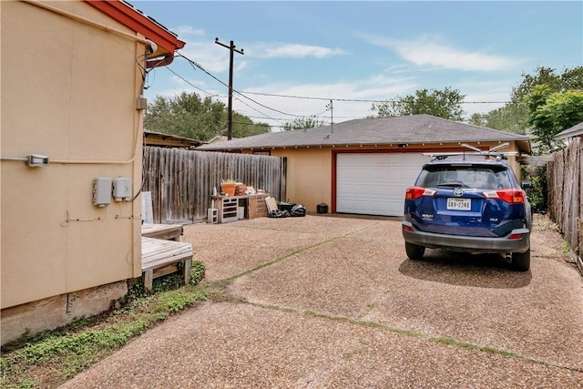exterior space featuring fence and a detached garage