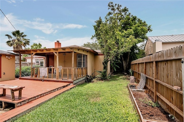 view of yard with fence and a deck
