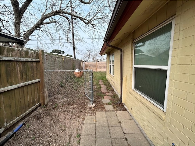 view of side of home featuring a fenced backyard