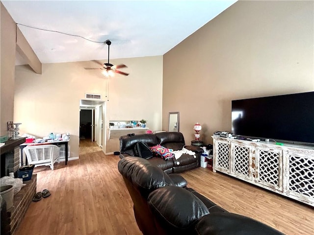 living room featuring high vaulted ceiling, wood finished floors, visible vents, and ceiling fan