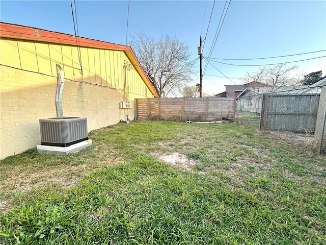 view of yard featuring central AC unit and a fenced backyard