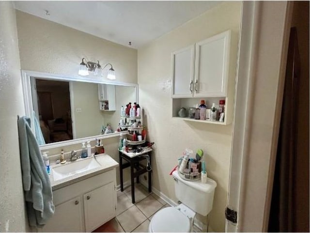 bathroom with tile patterned flooring, toilet, and vanity