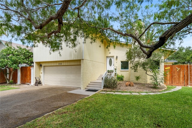 view of front of property featuring a garage and a front yard