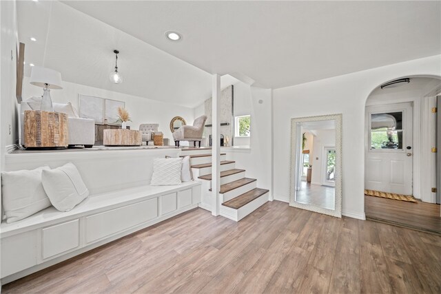 entryway with light hardwood / wood-style floors and vaulted ceiling