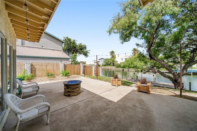 view of patio / terrace featuring a fire pit and a water view