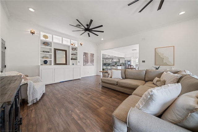 living room featuring ornamental molding, ceiling fan, and dark hardwood / wood-style floors