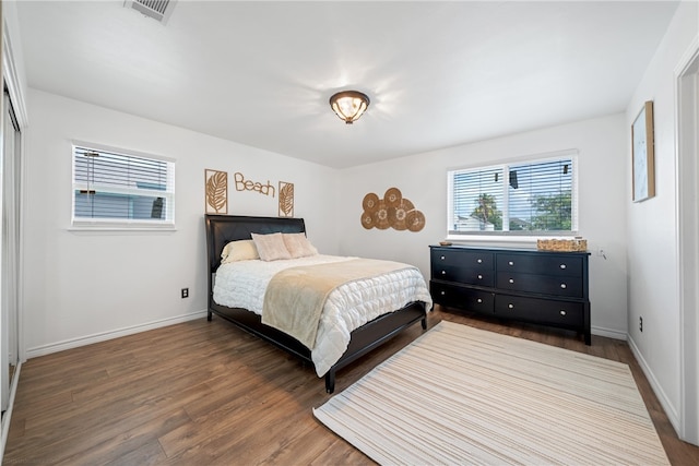 bedroom with dark wood-type flooring