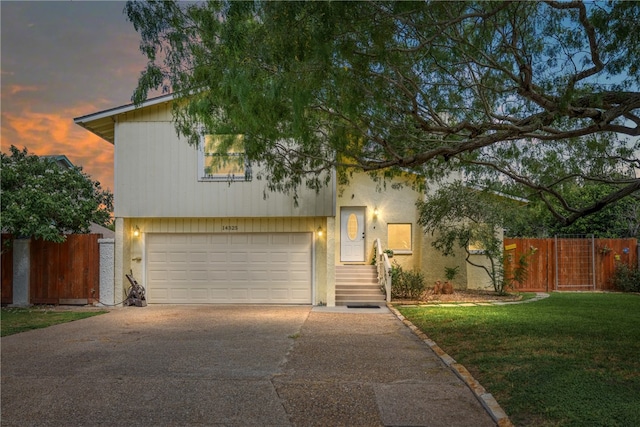 view of front of home featuring a lawn and a garage