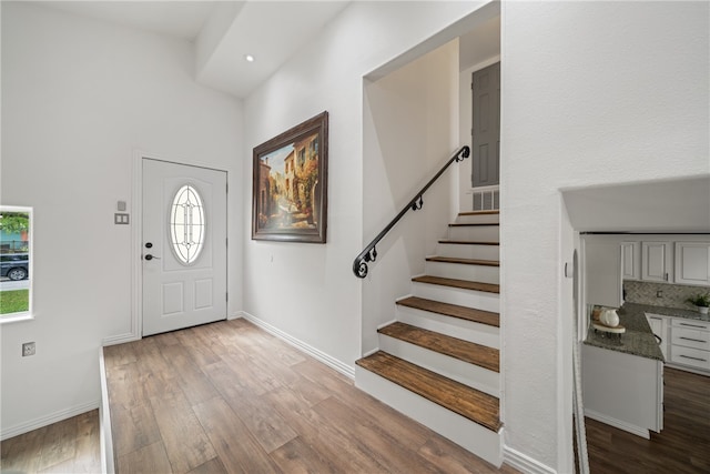 entryway with a healthy amount of sunlight and light hardwood / wood-style flooring