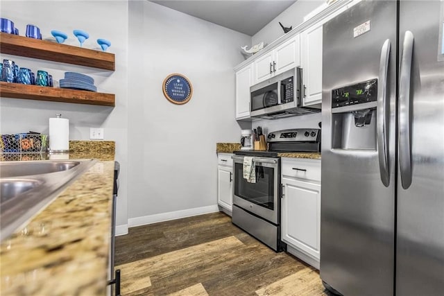 15022 Beach Walk, Corpus Christi, TX 78418 - kitchen with dark wood-type flooring, stainless steel appliances, and white cabinetry