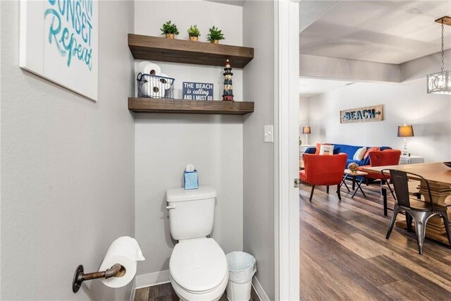 15022 Beach Walk, Corpus Christi, TX 78418 - bathroom featuring hardwood / wood-style floors, toilet, and an inviting chandelier