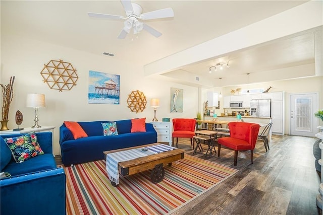 living room with ceiling fan and dark hardwood / wood-style flooring