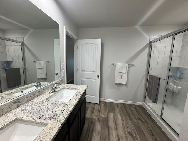 2682 Excelsior Blvd, Corpus Christi, TX 78415 - full bathroom with wood finished floors, a shower stall, double vanity, and baseboards