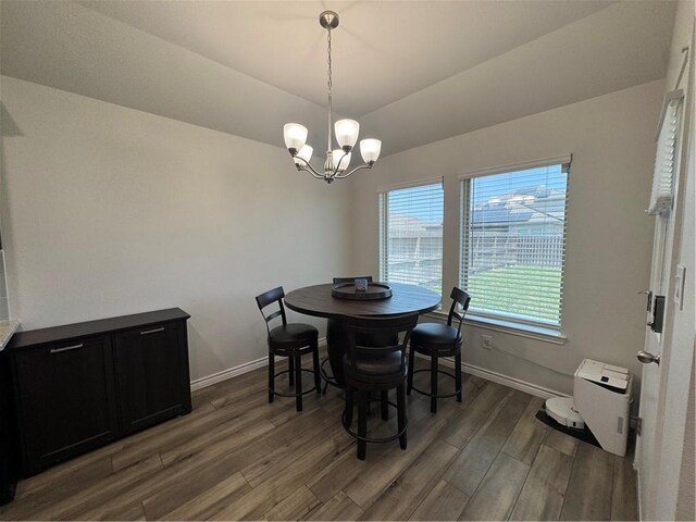 2682 Excelsior Blvd, Corpus Christi, TX 78415 - dining area featuring light wood-type flooring, a chandelier, baseboards, and lofted ceiling