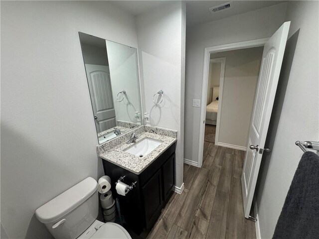 2682 Excelsior Blvd, Corpus Christi, TX 78415 - half bath with wood finished floors, vanity, toilet, and baseboards