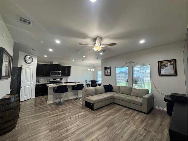 2682 Excelsior Blvd, Corpus Christi, TX 78415 - living room featuring ceiling fan, wood finished floors, recessed lighting, a chandelier, and baseboards