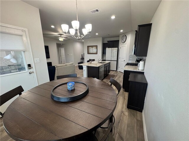 2682 Excelsior Blvd, Corpus Christi, TX 78415 - dining space featuring a chandelier, light wood-type flooring, recessed lighting, and baseboards