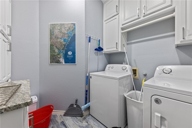 laundry area featuring cabinets and independent washer and dryer