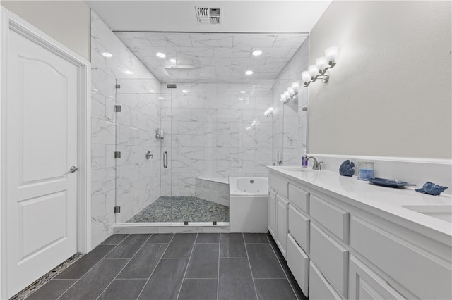 bathroom with vanity and separate shower and tub