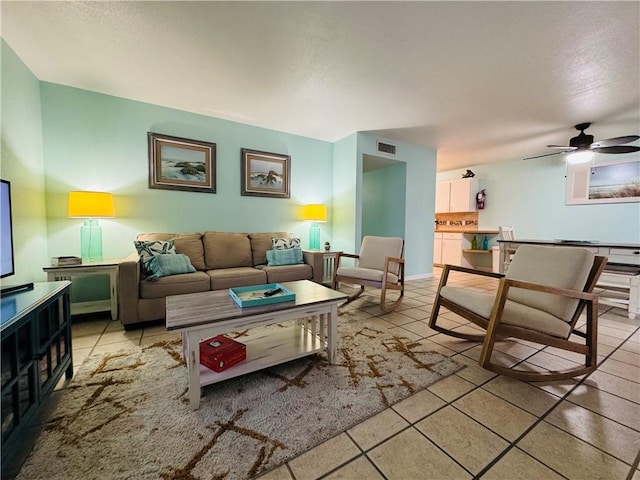 tiled living room featuring ceiling fan