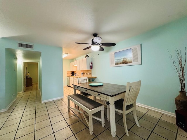 dining room featuring ceiling fan and light tile patterned floors