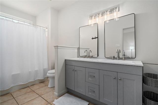 full bathroom featuring tile patterned floors, vanity, toilet, and shower / bath combination with curtain