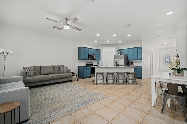 tiled living room featuring ceiling fan and crown molding