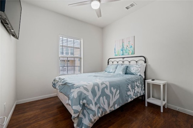 bedroom with ceiling fan and dark hardwood / wood-style flooring