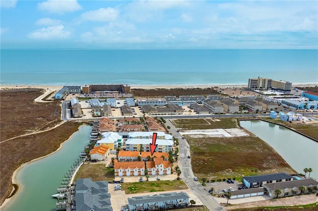 drone / aerial view with a water view and a view of the beach