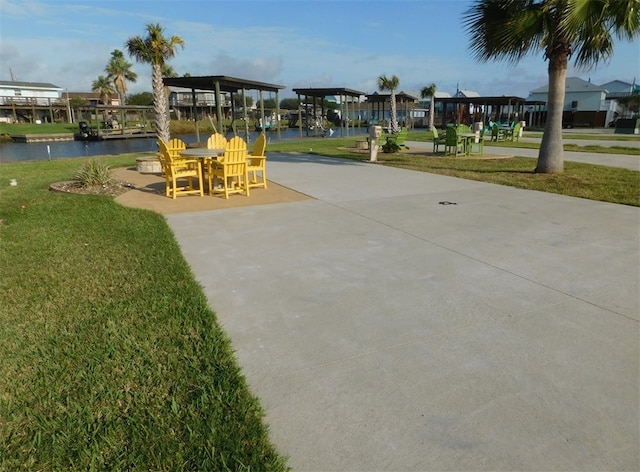 view of community with a water view and a yard