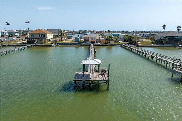 dock area with a residential view and a water view