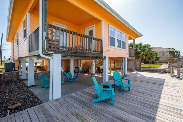 630 Copano Cv, Rockport, TX 78382 - back of property with a deck, a patio area, and central AC