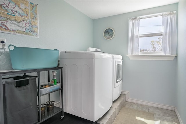 630 Copano Cv, Rockport, TX 78382 - washroom featuring tile patterned flooring, laundry area, washing machine and dryer, and baseboards